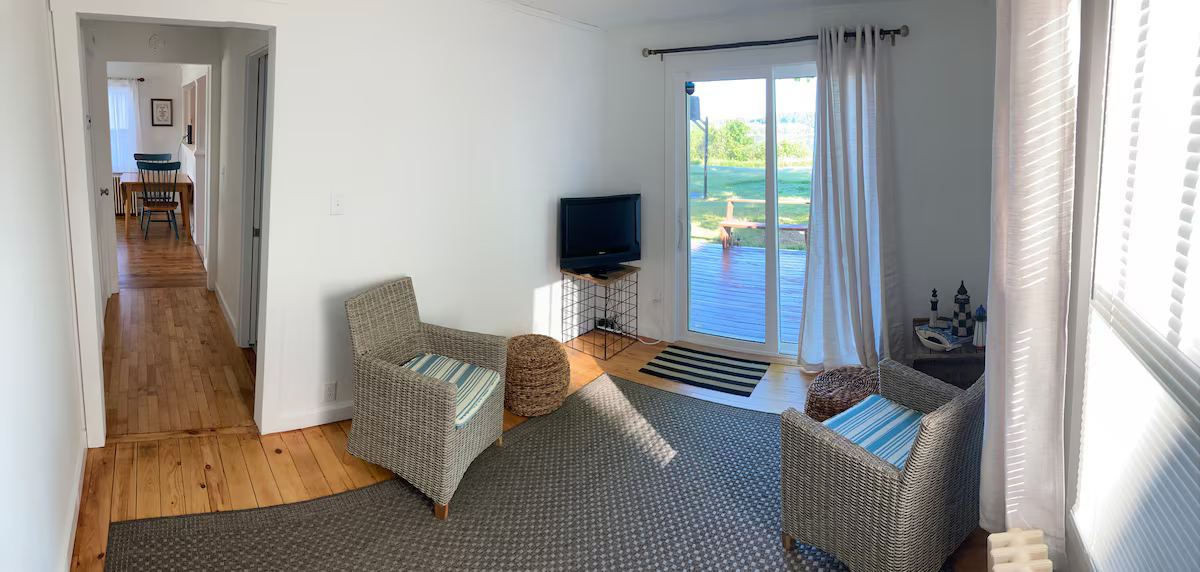 Sitting room with slider access to deck, watch a movie and the sunset! at Lubec Saltbox in Lubec