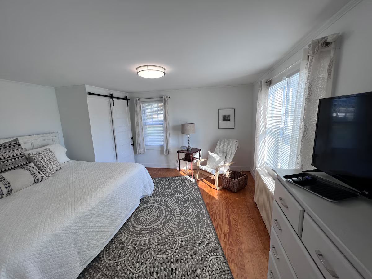First floor master bedroom with king size bed and TV. at Lubec Saltbox in Lubec