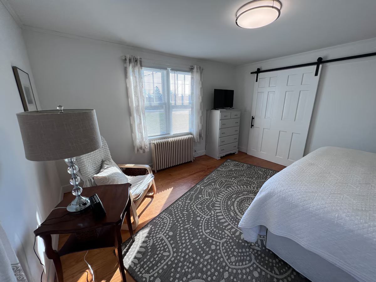First floor master bedroom with king size bed and TV. at Lubec Saltbox in Lubec