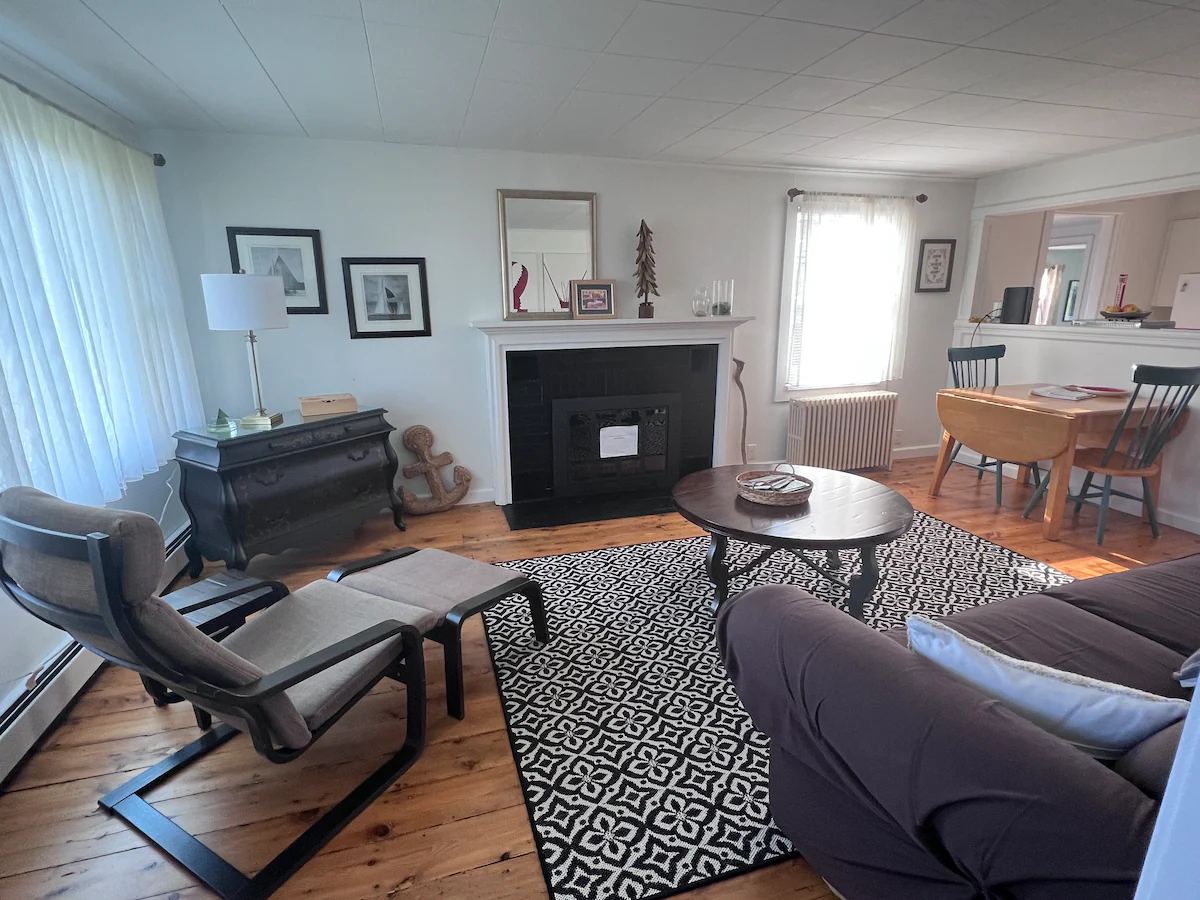 Living room with spacious seating and small table. at Lubec Saltbox in Lubec