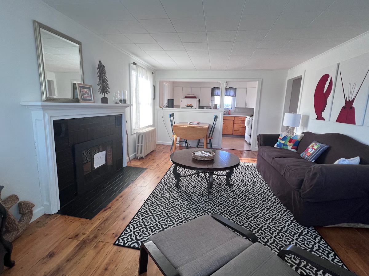 Living room with spacious seating and small table. at Lubec Saltbox in Lubec