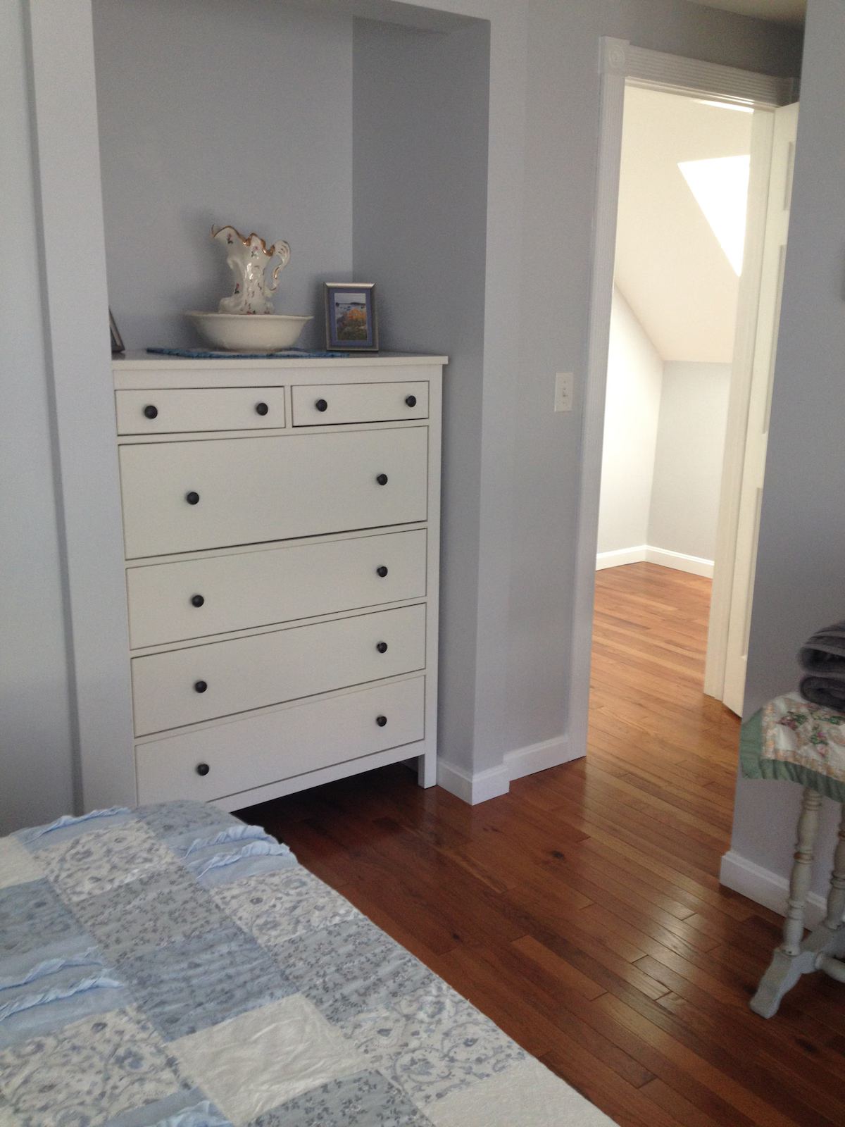 The master bedroom is upstairs - the skylight is at the top of the stairs. The big dresser tucks back into a nook and the closet is hidden to the right of the picture, just inside 