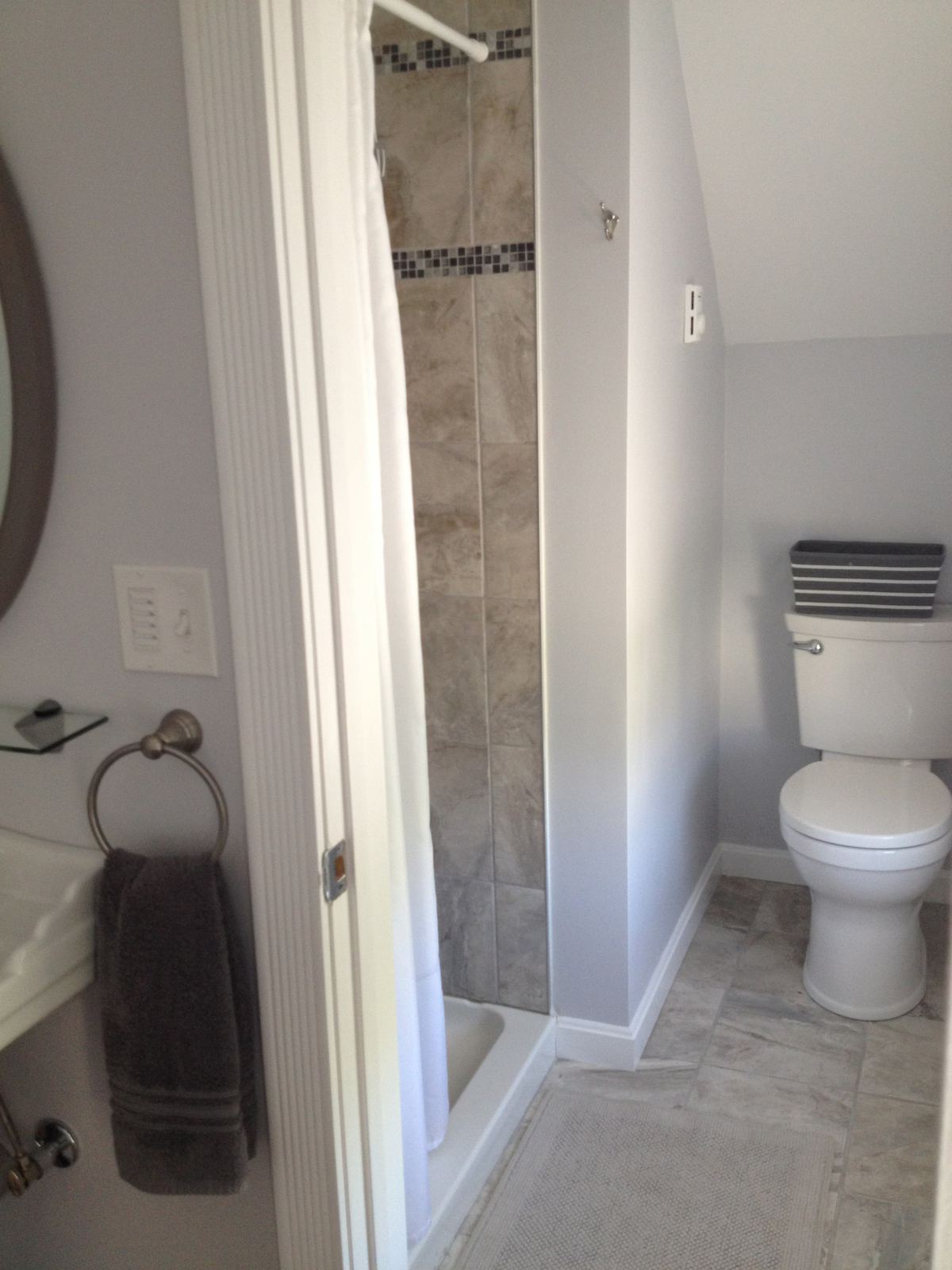 The master bedroom has an ensuite bathroom with shower and toilet. The sink is in the room. The shower is 42" wide and 30" deep. The angle of the photo makes it look small - but it