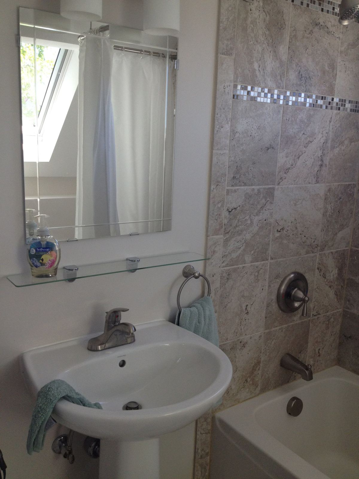 The hall bath has a lovely deep tub, its own hairdryer, and a shower. illuminated by both a skylight and a window, it is a great place for a good soak and a read. at Horror Hill Co
