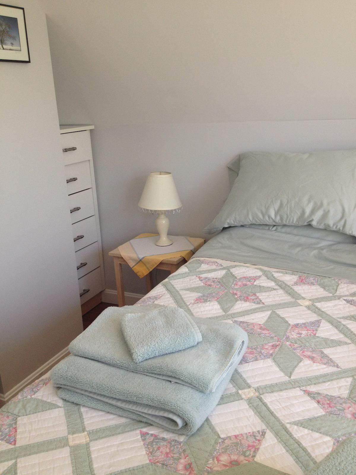 The smaller bedroom has a queen bed, a nifty little dresser backed into a niche, a good-sized closet and plenty of hooks. There's also another small dresser. It has a view of the w