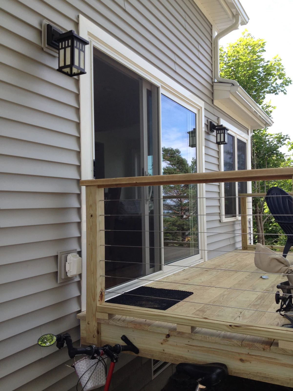 The 14' x 16' deck has see-through sides. That's my bike peeking out below! I grocery shop by bike! at Horror Hill Cottage in Lubec
